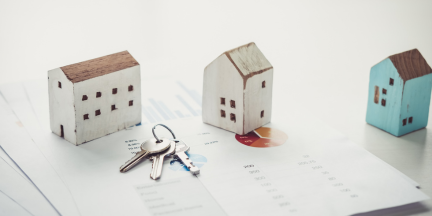 Image of 3 toy homes on a tabletop with a set of keys for the Tenant Protection for Renters program.