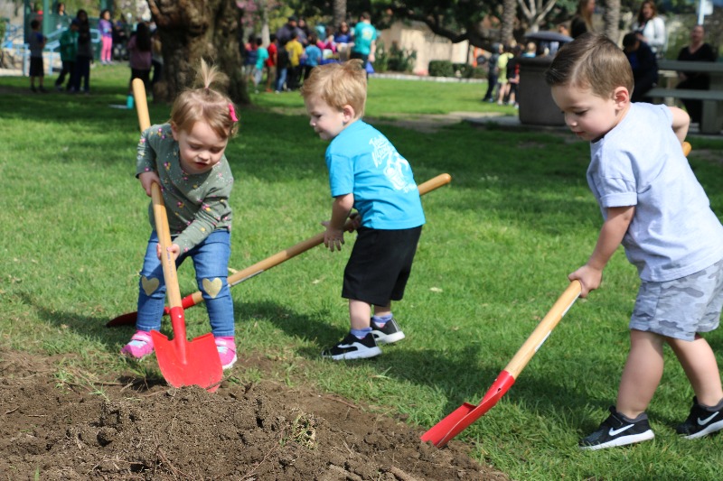 A mother and daughter participate in a tree planting