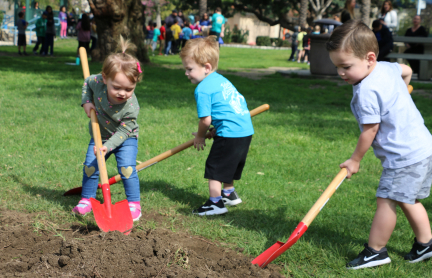 A mother and daughter participate in a tree planting