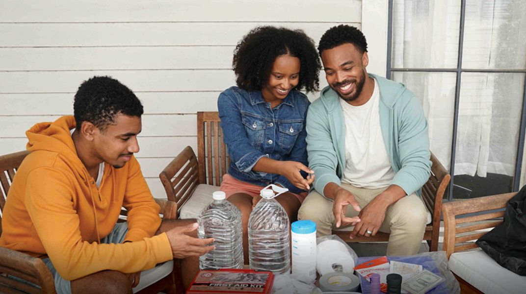 family preparing their household disaster kit together