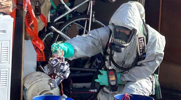 member of hazardous response team handling hazardous materials