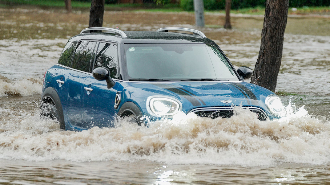 car diving through a flooded street
