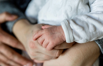 family holding hands with toddler
