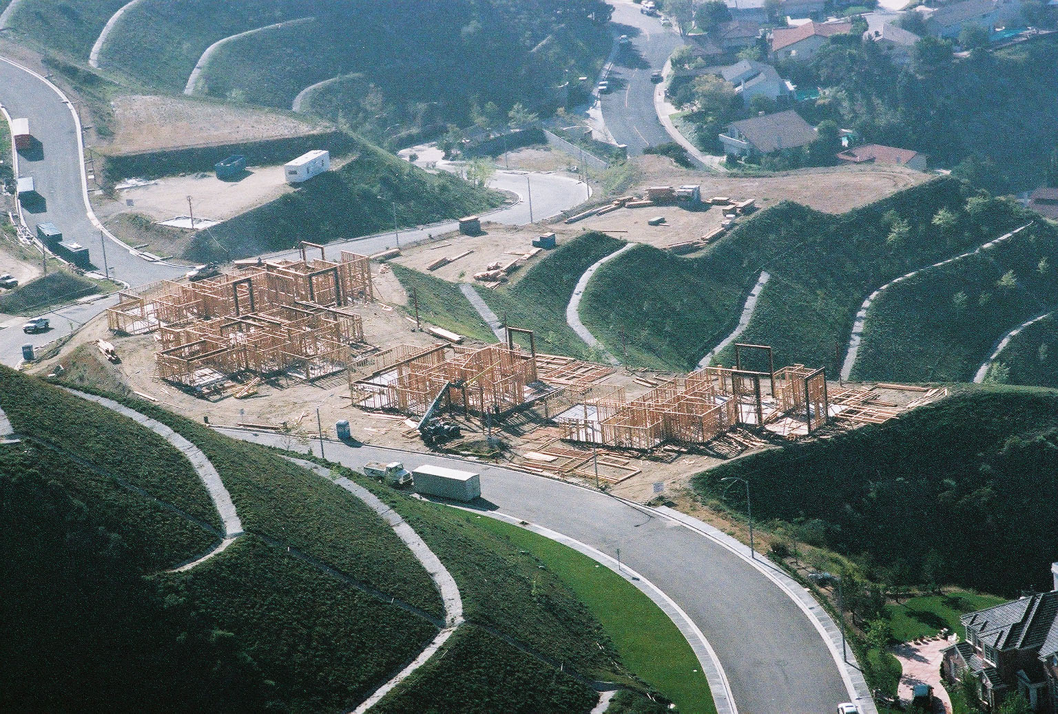 Overhead shot of building construction site, with several wooden frames