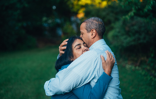 older couple hugging and giving support