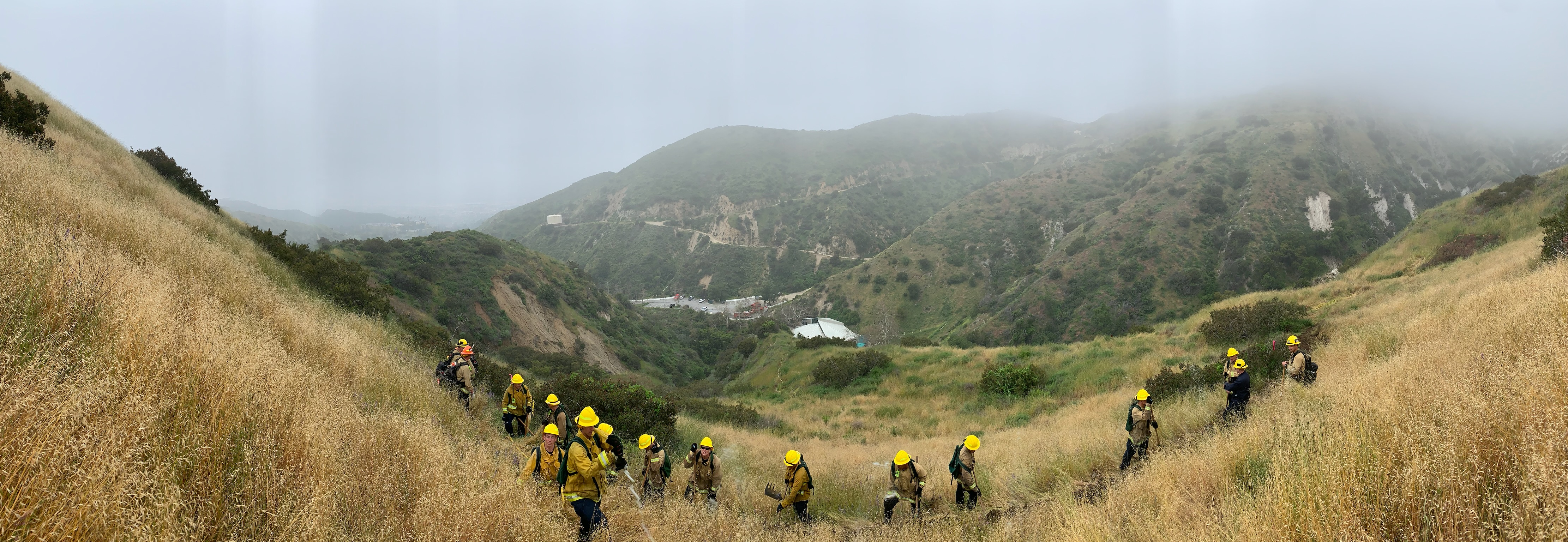 Firefighters in the hills above Burbank, putting out a fire on a hazy day