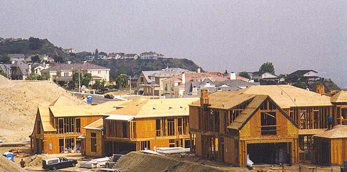 Image of a sprinkler spraying water onto a green lawn.