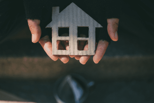 Image of a sprinkler spraying water onto a green lawn.