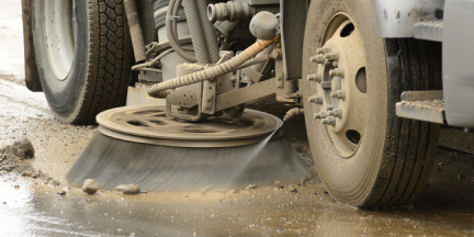 close up of street sweeping equipment